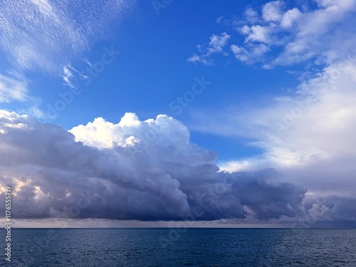 Fototapeta Naklejka Na Ścianę i Meble -  Dramatic sky big thunder clouds over the sea.