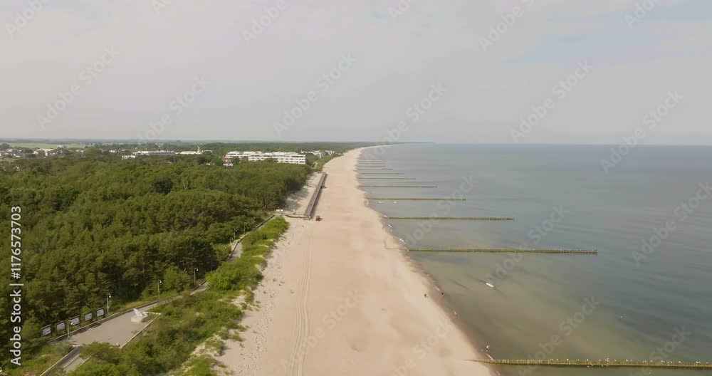 Aerial view circling the Plaza Mielno beach, sunny, summer day in Poland