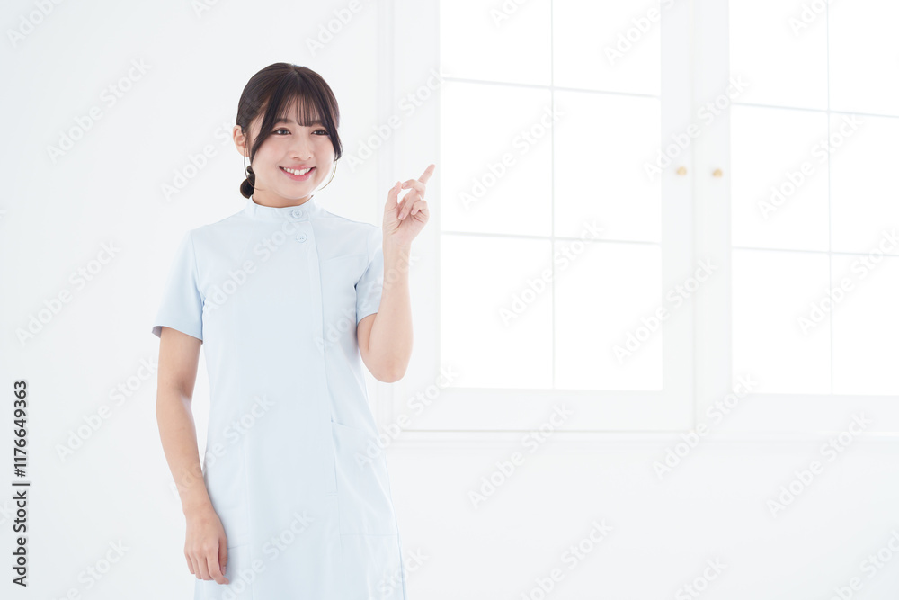 指差す笑顔の女性看護師