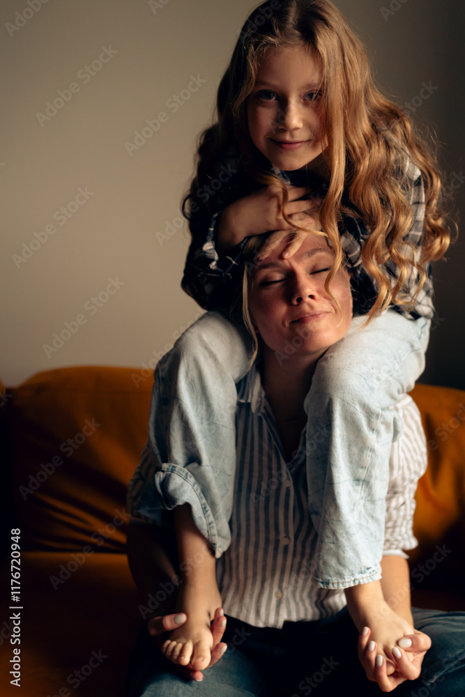 Mom and daughter hugging and laughing, sit on the neck Mom and daughter hugging and laughing, sit on the neck