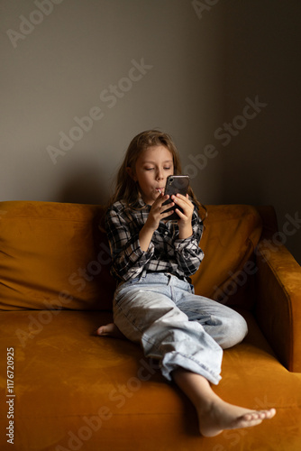 Side view of teenage girl using smart phone photo