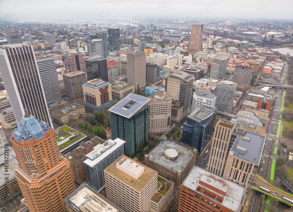 A city view from above with tall buildings and a green space