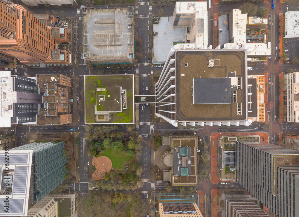 A city view from above with tall buildings and a park