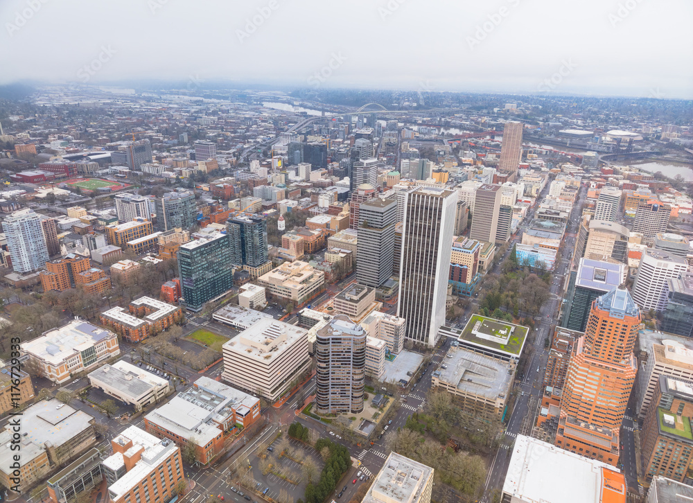 A city view from above with tall buildings and a green roof