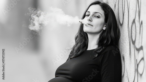 Smoking pregnant woman against a graffiti wall - careless pregnancy concept.