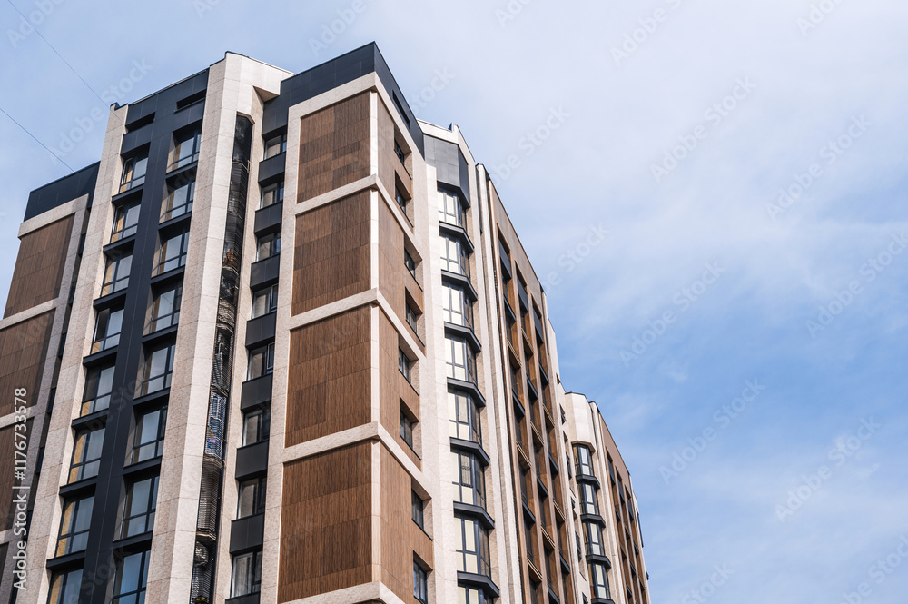 The facade of a new apartment building against the sky . The facade of a new apartment building against the sky .