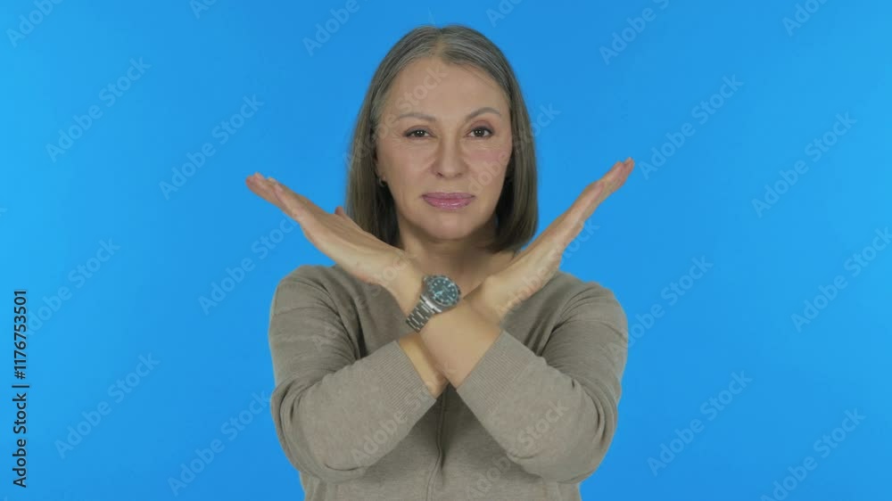 Tense Old Woman in Denial on Blue Background, Portrait