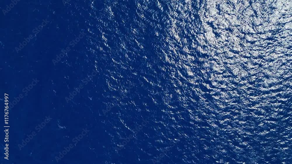 High aerial top down static view of deep blue ocean water, showing smooth surface texture and ripples