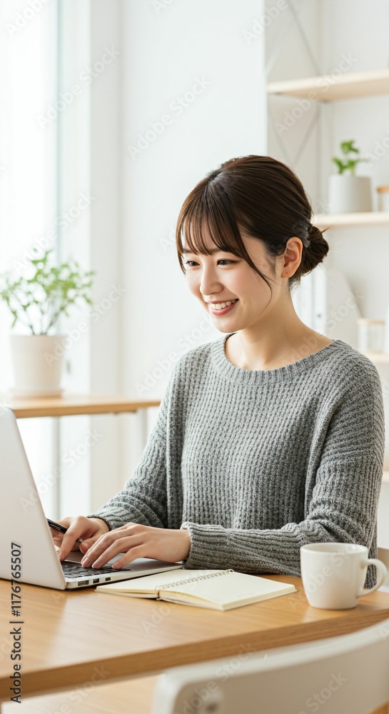 Professional Japanese Freelancer in Her 20s or 30s with Sleek Updo Hairstyle Typing on a Laptop in a Bright Home Office Professional Japanese Freelancer in Her 20s or 30s with Sleek Updo Hairstyle Typing on a Laptop in a Bright Home Office