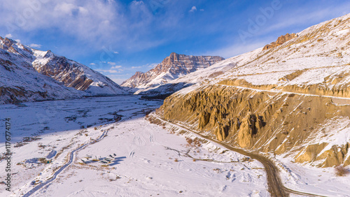 snowy mountain ranges with rugged cliffs and winding roads Himchal winter drone image photo