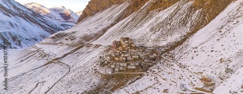 A breathtaking aerial view of Key Monastery perched atop a rugged hill, surrounded by barren, snow-dusted mountains. spiti photo