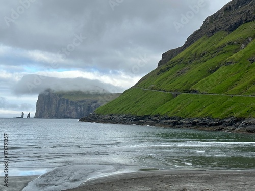 View of the coast of the Atlantic Ocean and Risin og Kellingin sea rocks from Tjørnuvík village, Streymoy, Faroe Islands, August 2023 photo