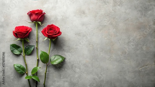 Red roses in a minimalist background with a single stem and green leaves on a neutral-colored surface