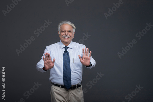 Handsome Senior Man In Sky Blue Shirt Making A Stop Sign�
