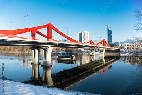 Photography New red bridge across the Moskva River connecting the Mnyovnikovskaya and Filevskaya floodplains and an electric tram floating on the river
