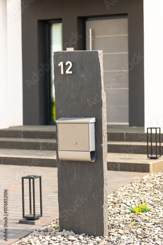 slate column with mailbox and house number in front of a front door