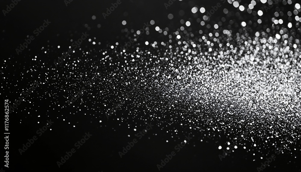 Obraz premium Sparkling silver particles creating a mesmerizing effect on a dark background for artistic and creative projects