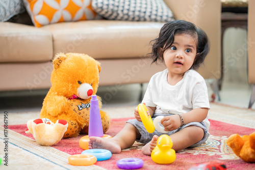 Indian Baby Playing With Toys Sitting On Mat
