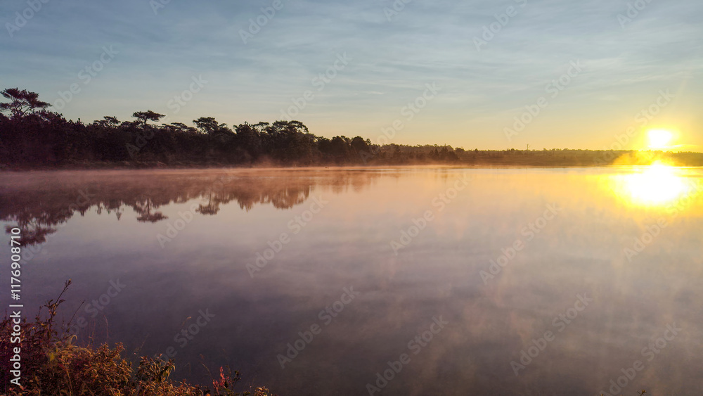 Fototapeta premium Fog is spreading over a lake in a morning
