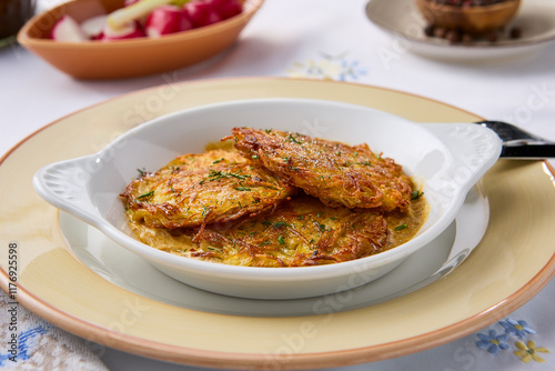 Crispy Golden Potato Pancakes on Elegant Table Setting photo