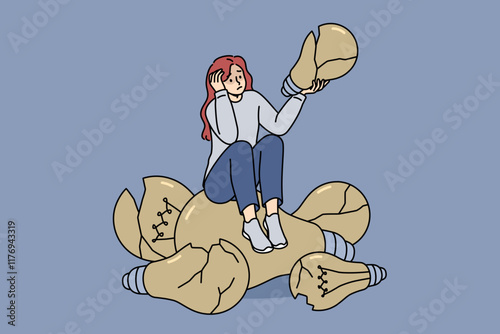 Loser woman sits on broken light bulbs symbolizing bad ideas and lack of further plan. Loser girl suffers from constant mistakes that negatively affect psychological health and mood.