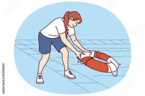 Woman throws lifebuoy into pool to help drowning or non-swimmer who has fallen into water. Smiling girl with lifebuoy stands near deep pool working as lifeguard in hotel or fitness club