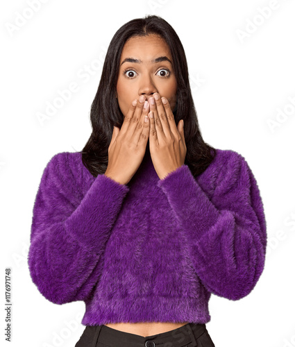 Young filipino woman shocked, covering mouth with hands, anxious to discover something new. photo