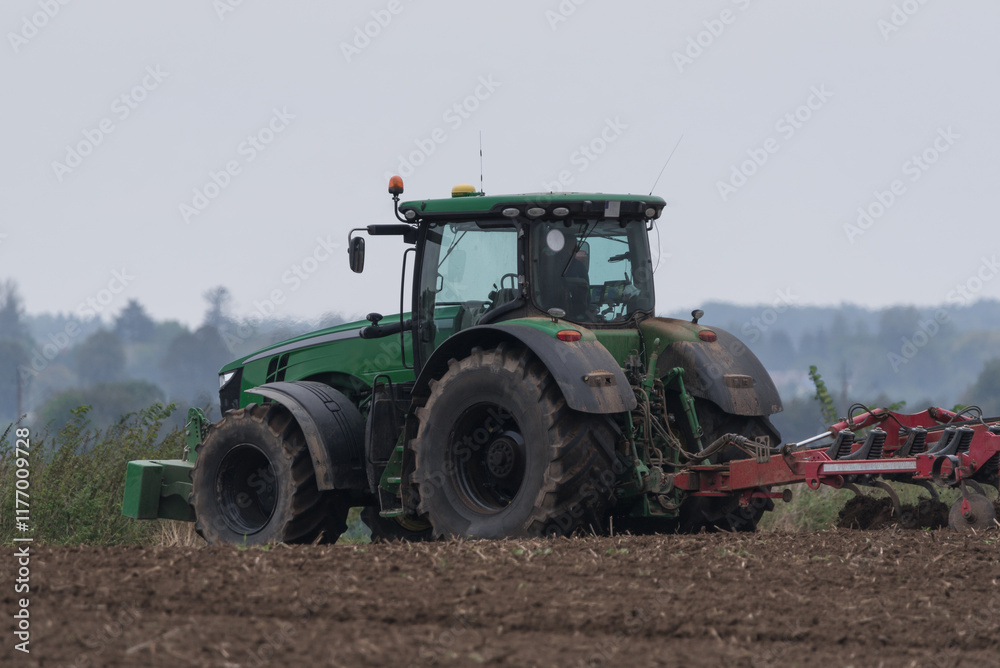 AGRICULTURE - Modern tractor with seeder in the field AGRICULTURE - Modern tractor with seeder in the field