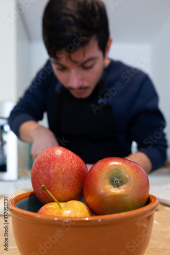 Wallpaper Mural Vertical image of a man making a delicious apple dessert, homemade food Torontodigital.ca