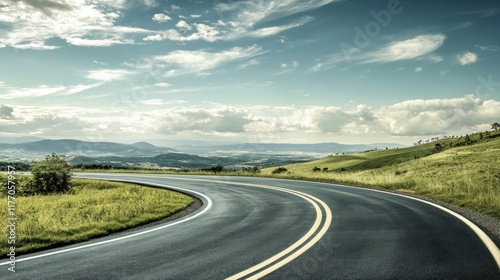 Scenic Highway Winding Through Rolling Hills Under a Blue Sky