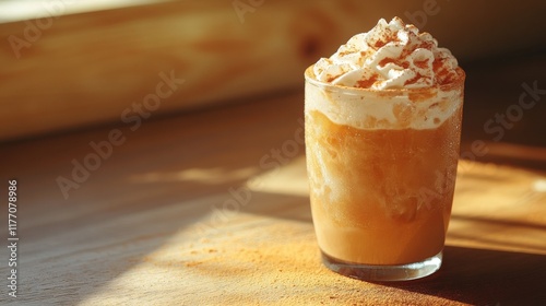 Creamy iced drink with whipped topping on wooden table in warm light