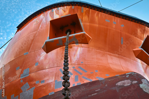 Close up of a ship's bow, with anchor chain lowered. photo