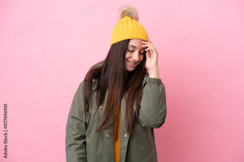 Young Ukrainian woman wearing winter jacket isolated on pink background laughing Young Ukrainian woman wearing winter jacket isolated on pink background laughing