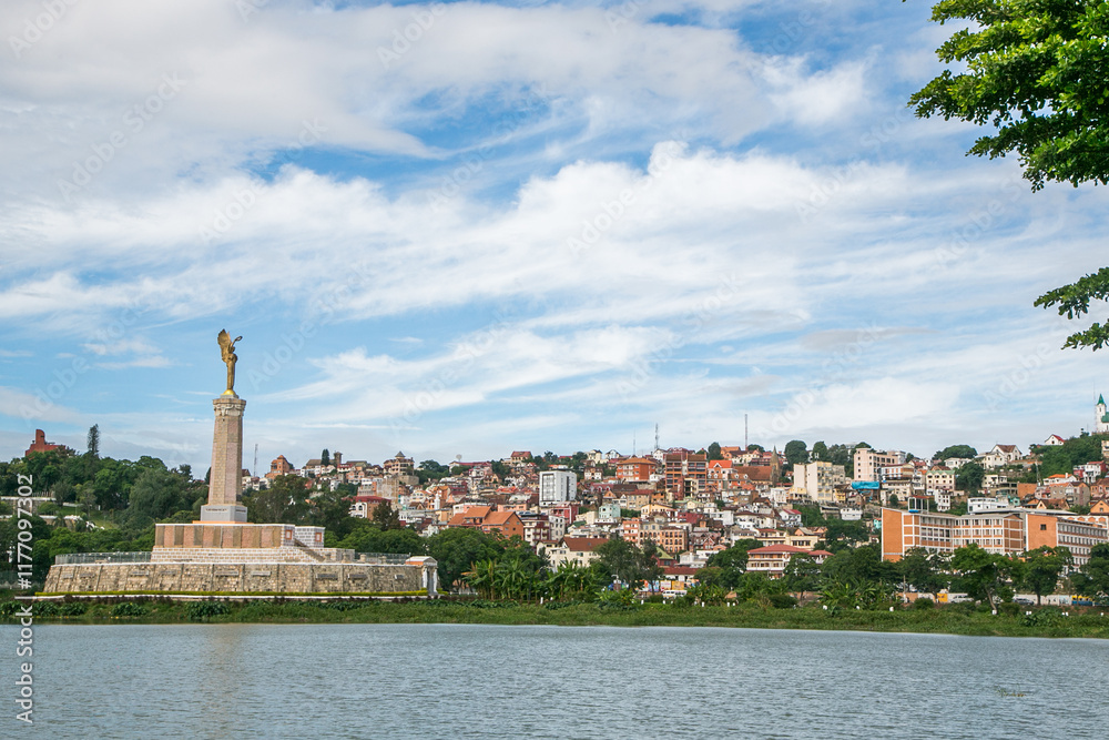 Fototapeta premium Photo of Antananarivo city with the emblematic angel's statue in the middle of Anosy lake