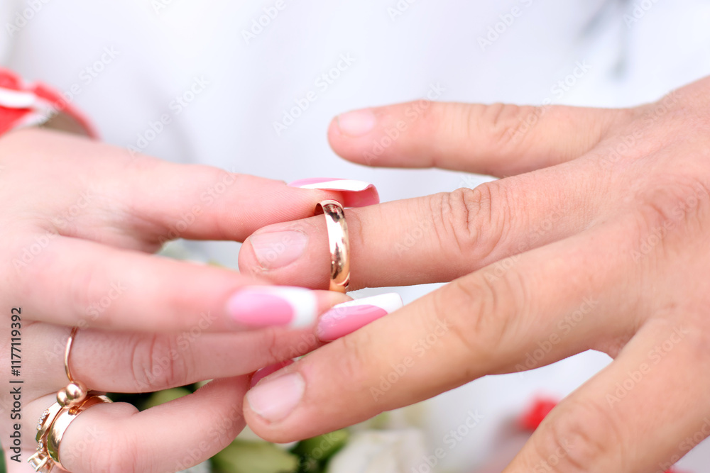 The groom puts a wedding ring on the bride's finger. Wedding ceremony. The groom puts a wedding ring on the bride's finger. Wedding ceremony.