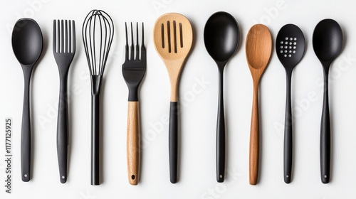 A group of kitchen utensils, such as spoons, tongs, and spatulas, isolated on a bright white surface. photo