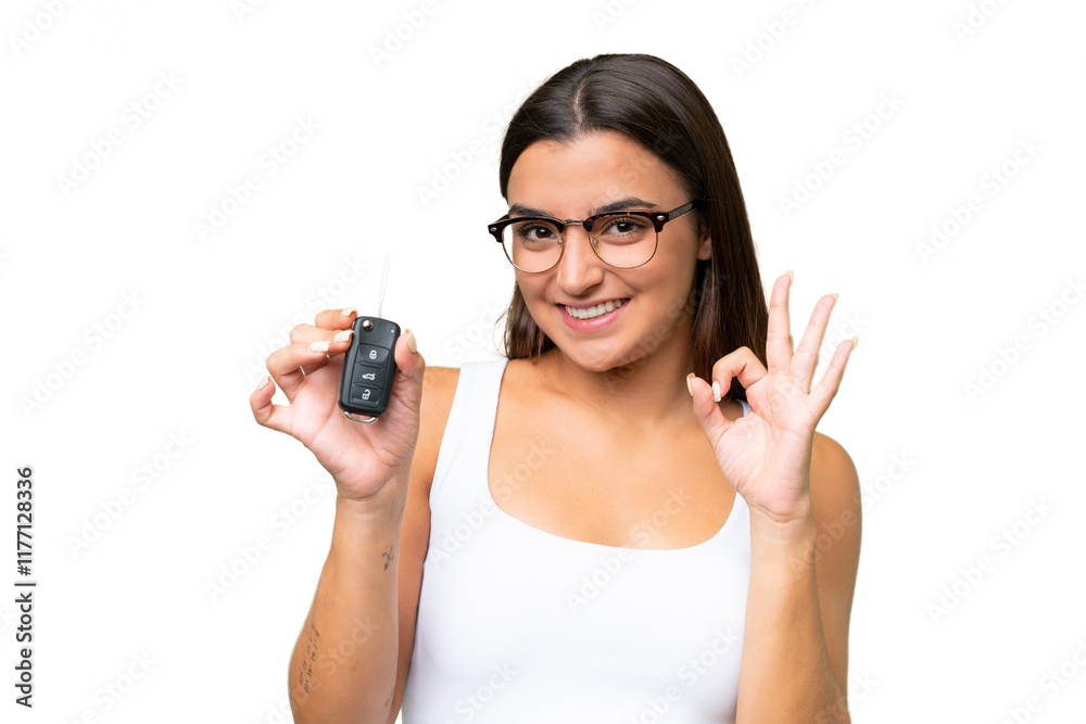 Young caucasian woman holding car keys isolated on green chroma background background showing ok sign with fingers Young caucasian woman holding car keys isolated on green chroma background background showing ok sign with fingers