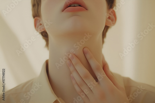 Handsome man with neck pain. Concept of sore throat, pharyngitis, laryngitis, thyroiditis, choking photo