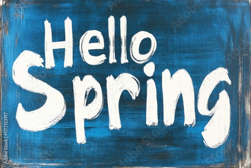 Hello spring greeting in white brush lettering on blue background