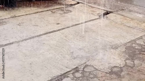 Heavy Rain Drops Falling From Roof.Rain flows from a house roof into a gutter during rain. close-up