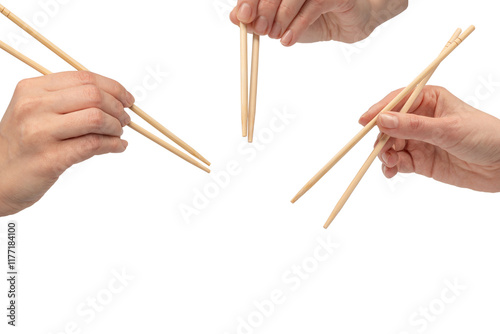 Wallpaper Mural Female hand holding wooden sushi chopsticks isolated on white background. Torontodigital.ca