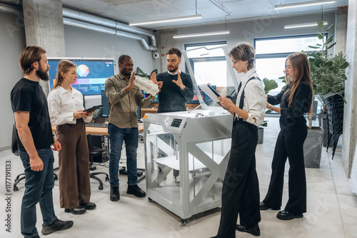 People are in the office by the 3d printer