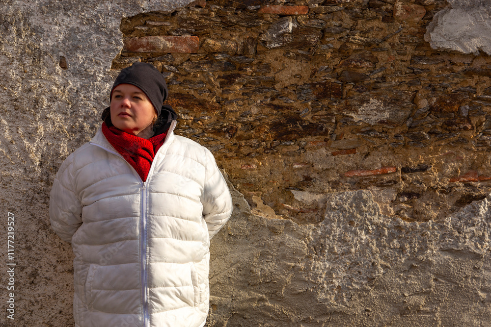 A plus-size woman strolling through the streets of a small European town.