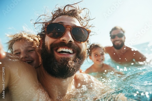 An engaging selfie highlighting a group of kids swimming joyfully with adults, embodying the spirit of happiness and relaxation during a summer outing by the sea.