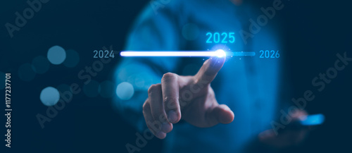 Obraz na płótnie Businessman touch on loading progress from 2024 to 2025, Planning and challenge strategy in new year 2025 Concept. New business startup in 2025. 2025 is loading to 2026, calendar date, end of the year w salonie