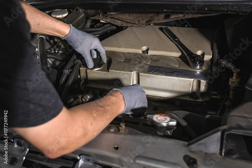 Car mechanic fixing car in auto repair service shop