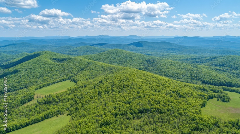 Naklejka premium A drone view of a green mountain range with layered peaks stretching into the distance