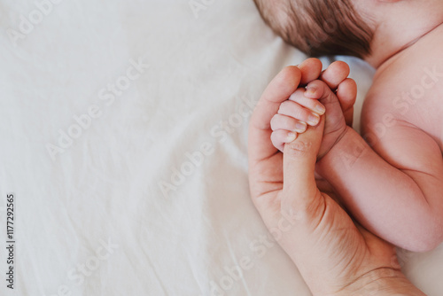 Close-up little hand of child baby holding hand of mother.