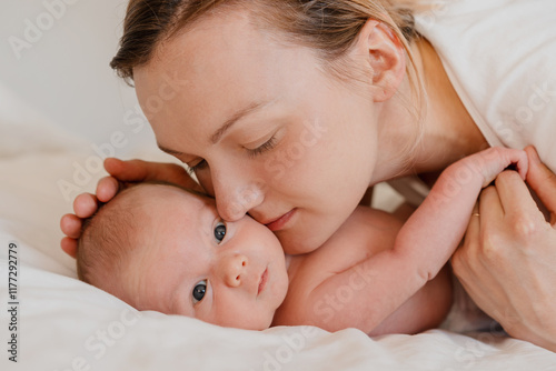 Mother and baby. Loving mom spending time with her little two week old child at home. photo