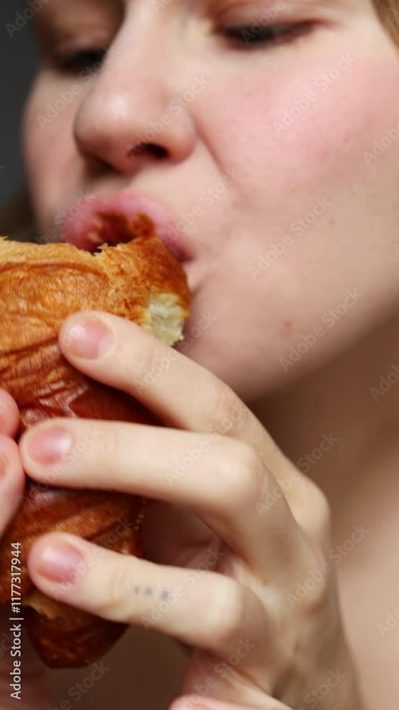 A person enjoys a fresh pastry, revealing its golden, flaky texture and soft, buttery interior in a cozy setting. A person enjoys a fresh pastry, revealing its golden, flaky texture and soft, buttery interior in a cozy setting.